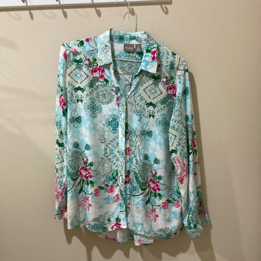 Long sleeve tunic-length blouse, aqua and white with rose design.